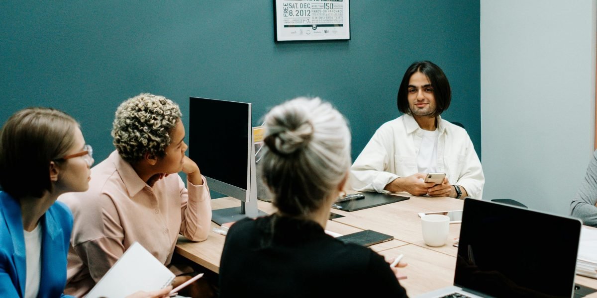 A diverse team of professionals actively discussing strategies and solving complex problems in a modern office environment.