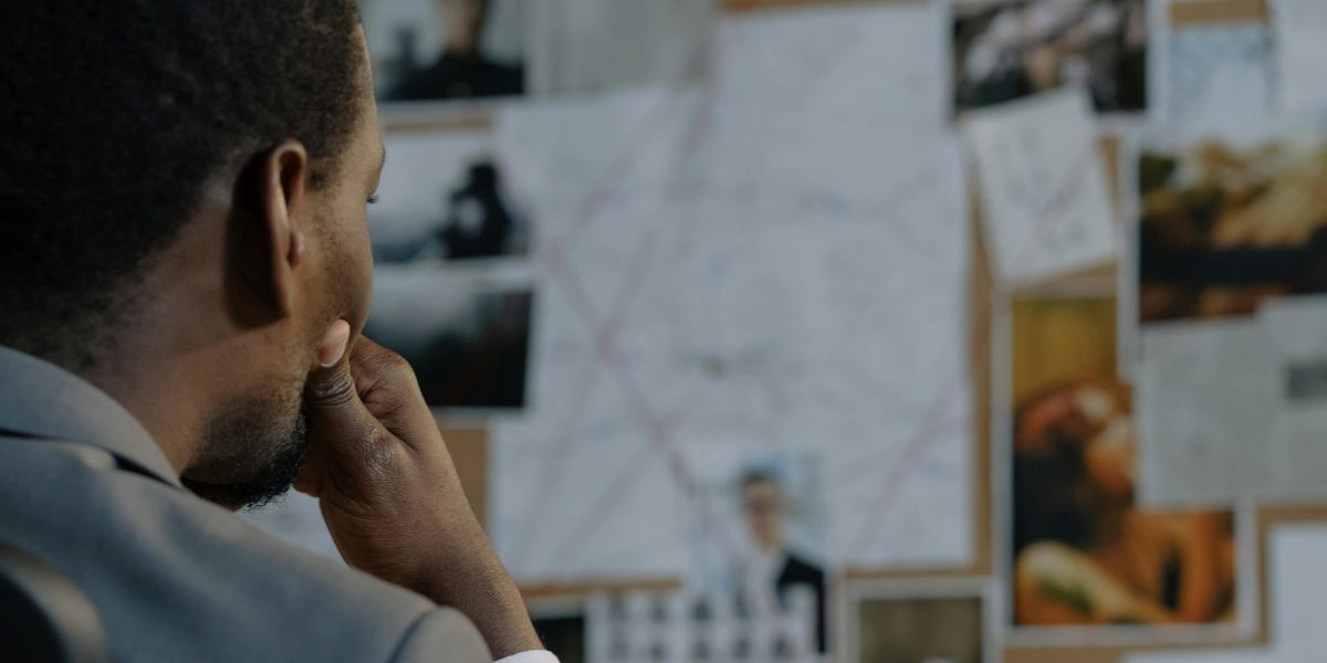 A leader demonstrating critical thinking by carefully considering evidence and questioning assumptions before making decisions.