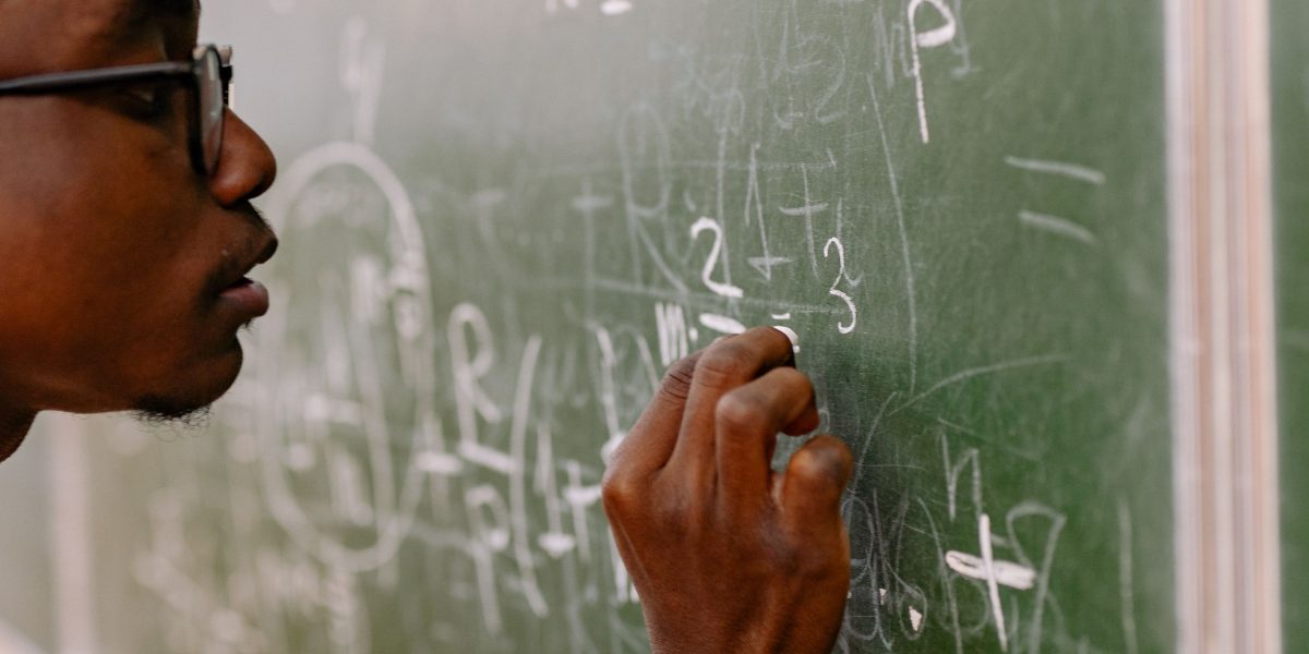 An individual thoughtfully working through a problem, symbolizing the effort to overcome intellectual challenges.