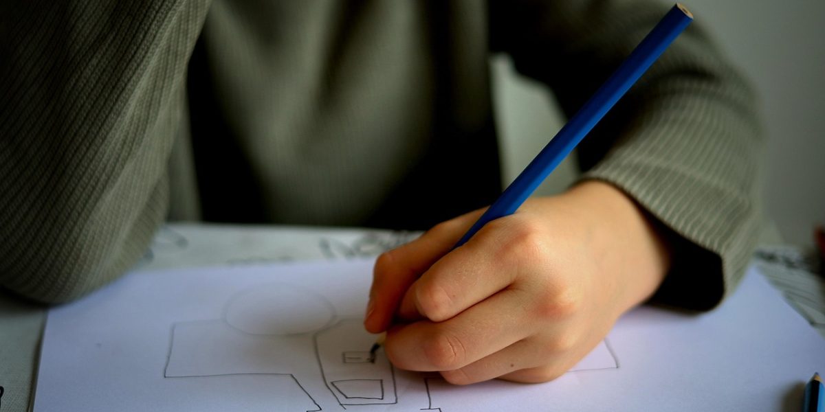 A student engaged in learning, receiving guidance and support to build mathematical understanding from an educator or parent.