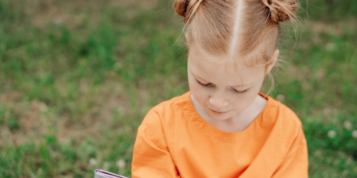 A young child appears confused while reading a book, highlighting common challenges in 3rd grade reading comprehension.