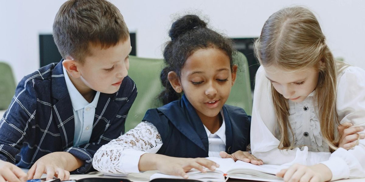 A small group of students collaborating on a reading activity in a classroom setting, benefiting from guided instruction.