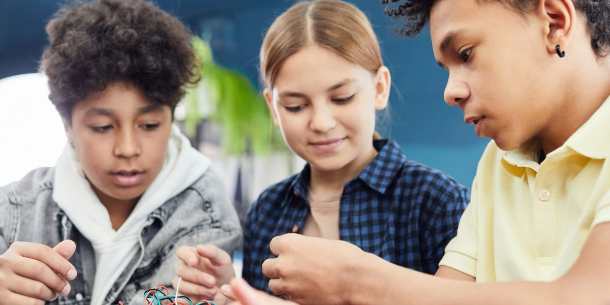 Children collaborating on a hands-on science project, demonstrating engagement in STEM-focused learning.