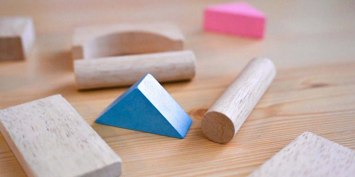 A child focused on playing with colorful blocks, representing hands-on learning.