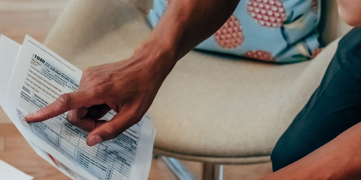 A family carefully reviews financial documents and budgets for educational expenses.