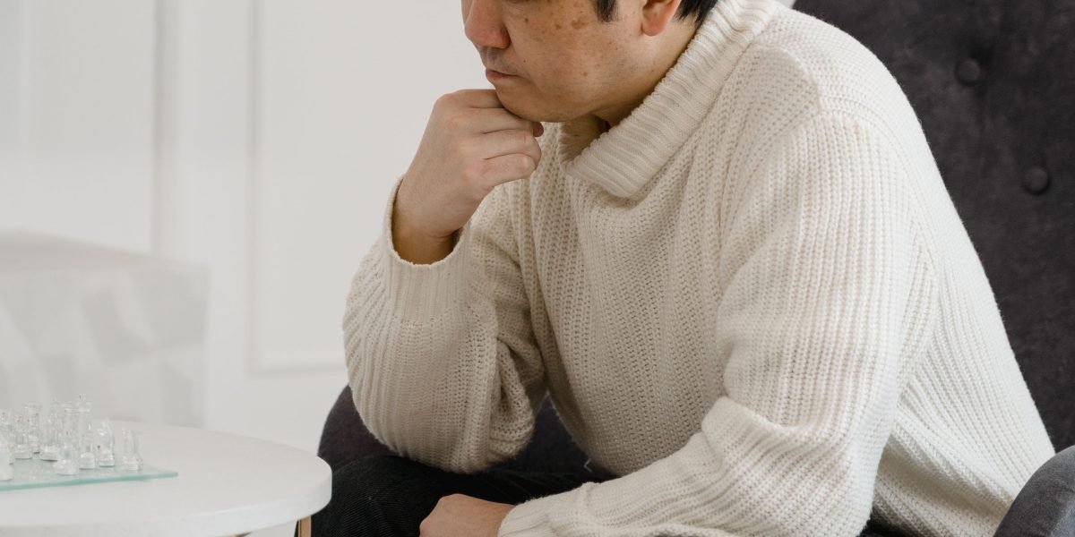 A parent thoughtfully reviewing educational materials, symbolizing the important decision of choosing a homeschool curriculum.